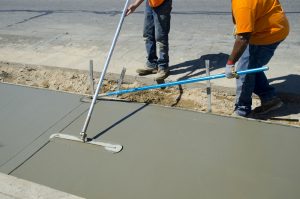 Workers laying concrete for a foundation in Buda